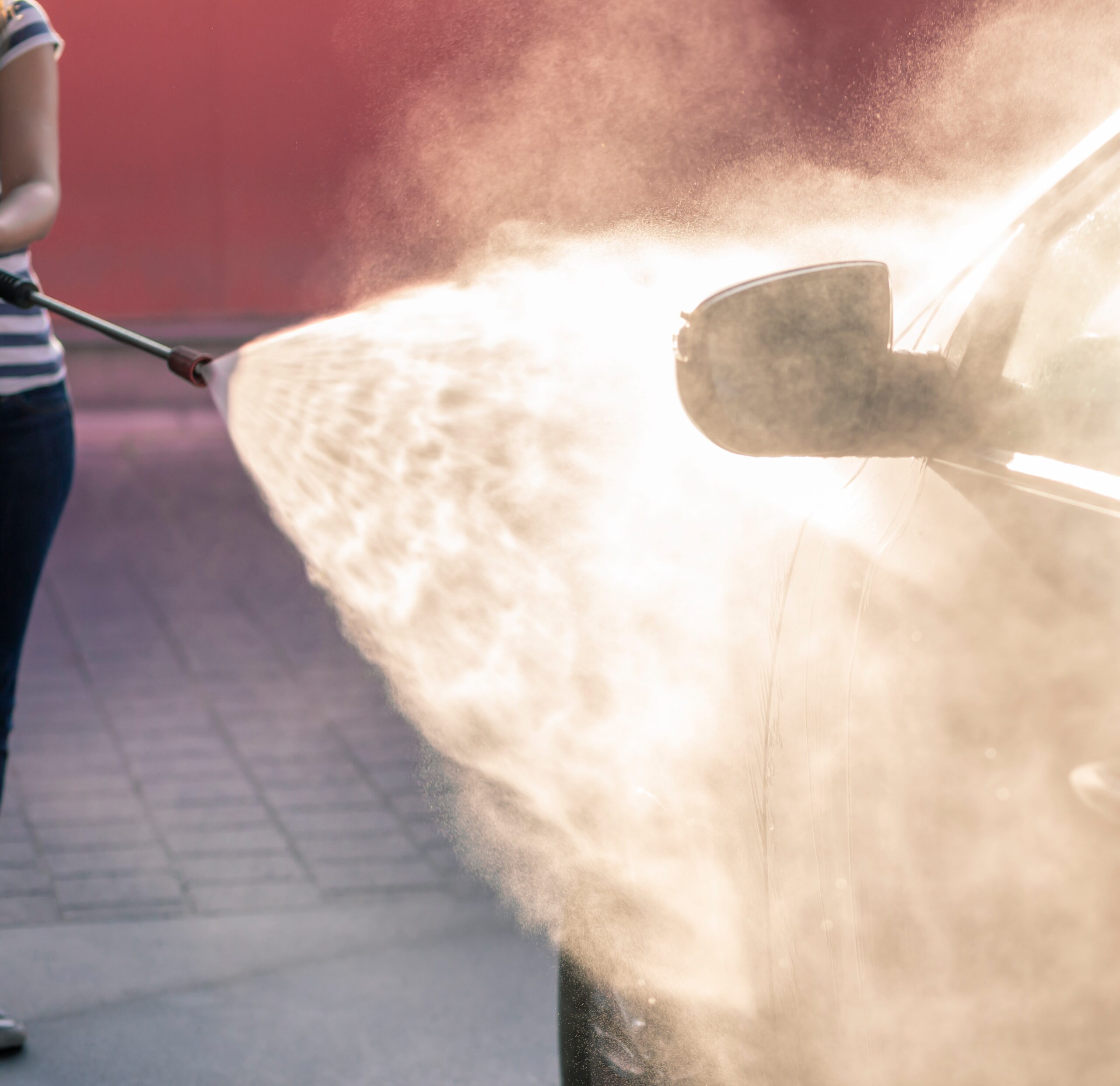 Woman washing a car in car wash